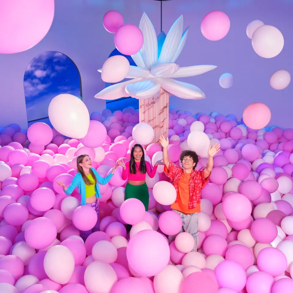 Visitors enjoying immersive bubble-themed rooms at Bubble Planet Dallas with colorful lighting and interactive installations